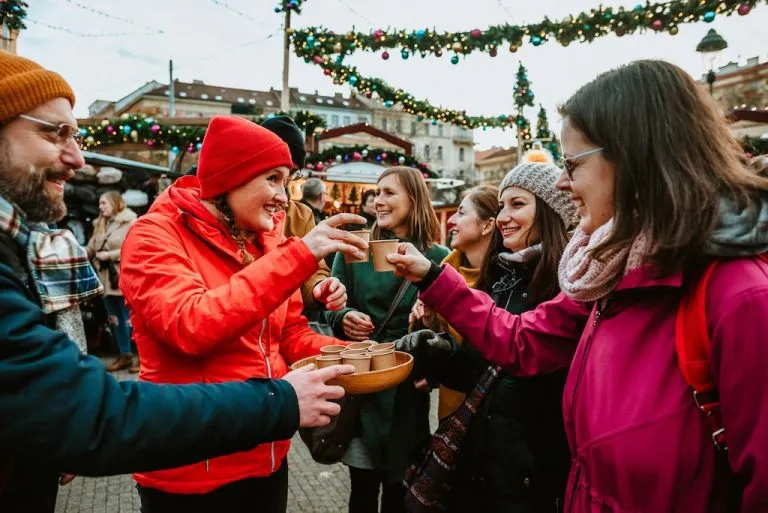 a tour guide shares hot mead with her guests on a private Christmas markets tour in Prague