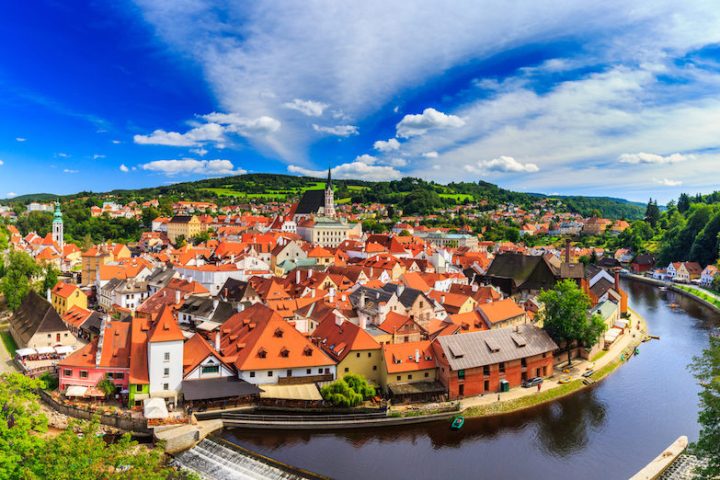 a panoramic view of the historic center of Český Krumlov surrounded by a river bend