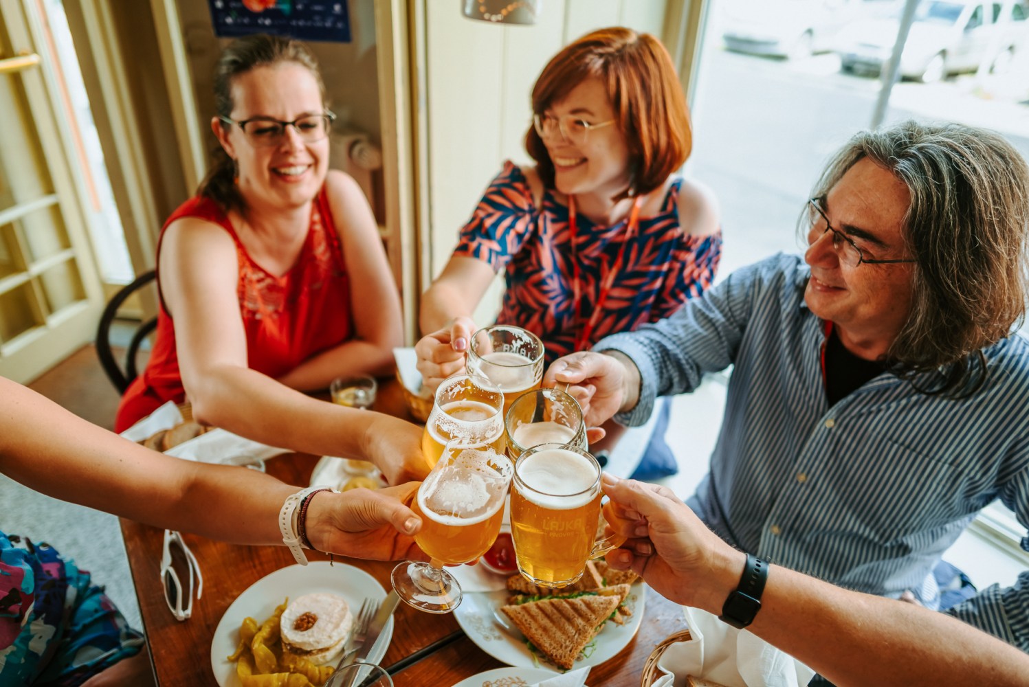 a group of tourists on a day tour to Pilsen enjoying a glass of beer