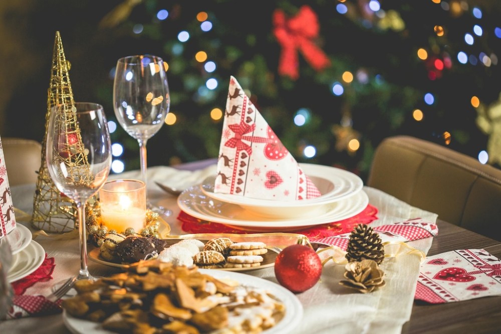 a table set for Christmas dinner or lunch, with decorated napkins and Christmas cookies