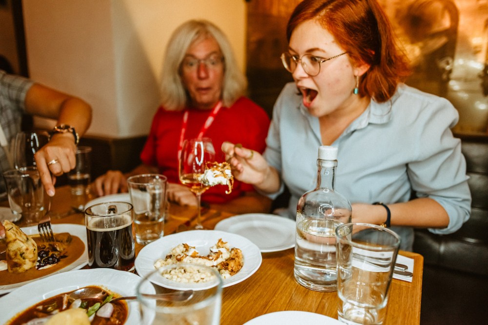 tourists in Prague enjoying traditional Czech cuisine in one of our favorite restaurants, recommended by our local guides