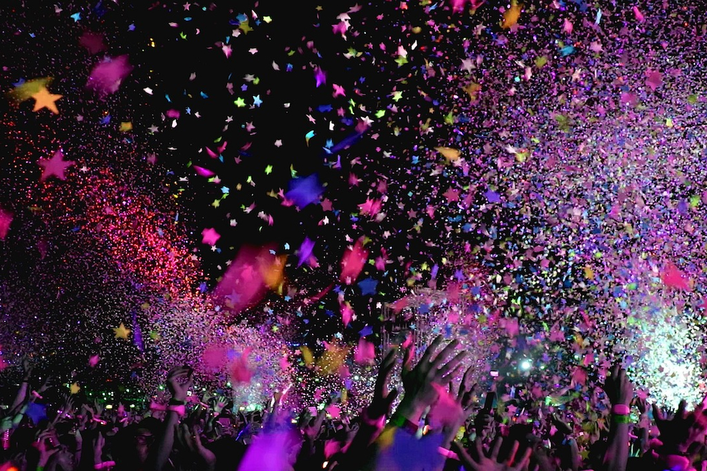 colorful confetti falling from the sky into a crowd of Swifties during one of Taylor Swifts' European concerts in her Eras Tour in 2024